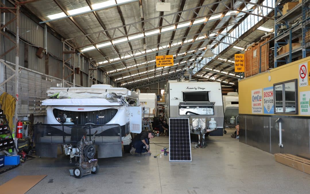 Caravans parked for service or storage inside a workshop