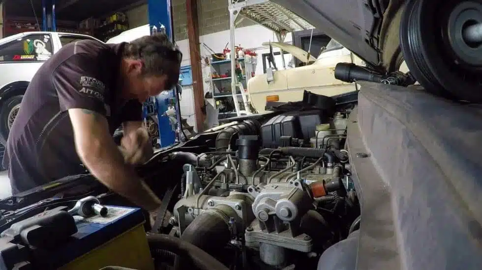 man fixing engine