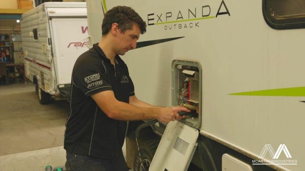 man flushing out hot water system in caravan man flushing out hot water system in caravan