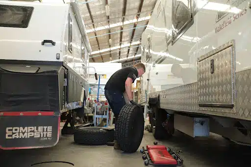 man carrying tires
