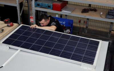 man fixing solar panel
