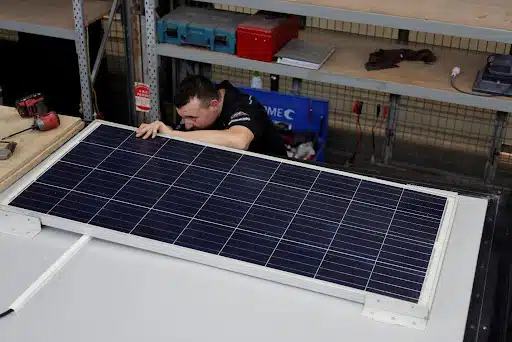 man fixing solar panel