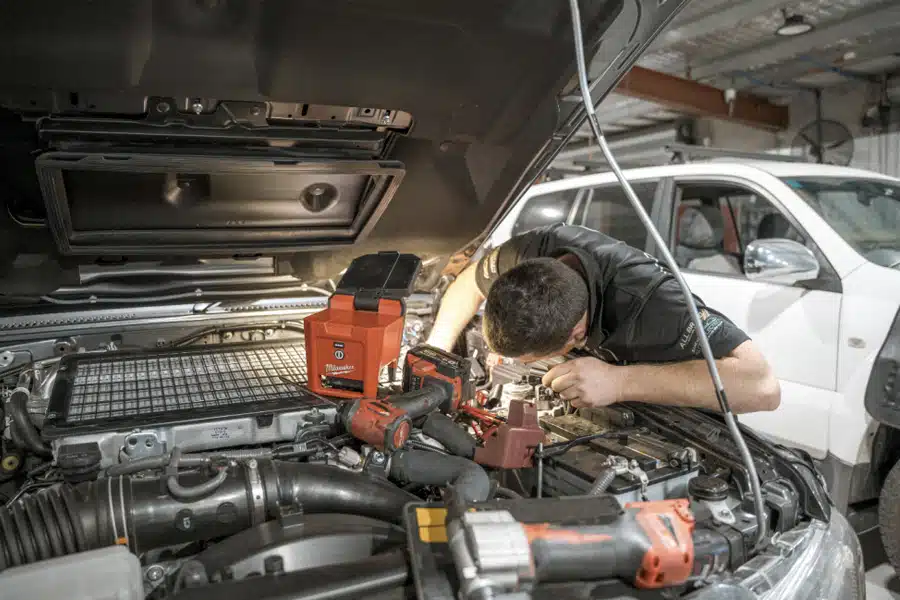 man checking front engine