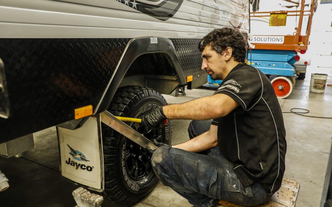 Caravan wheel maintenance: Technician inspects and repairs the tire