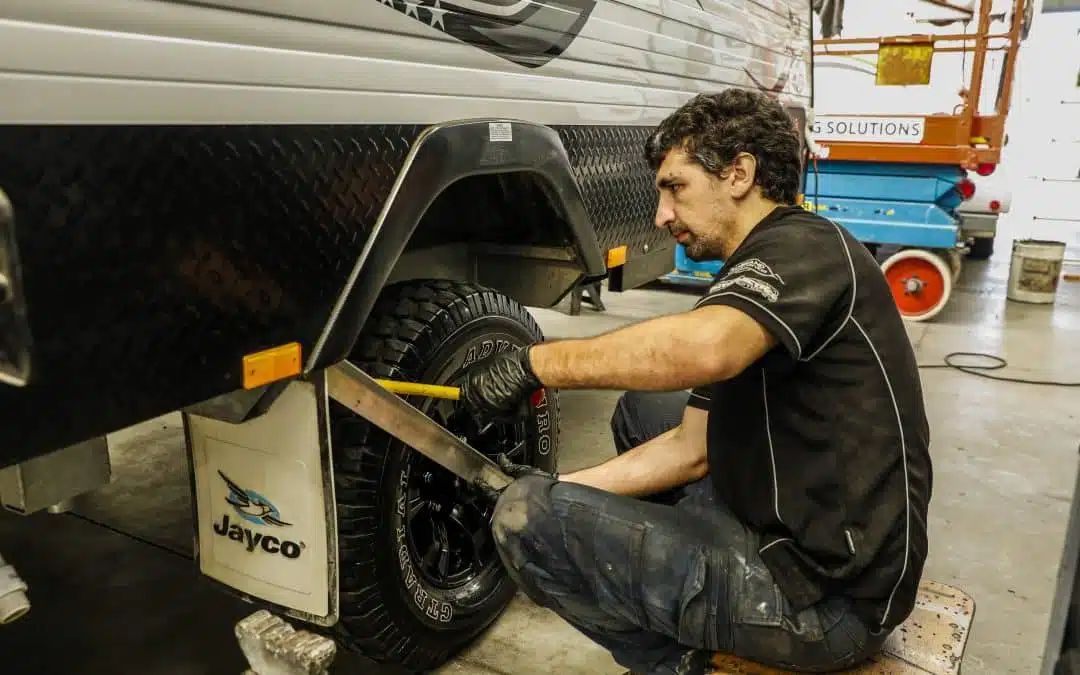 man fixing car wheels