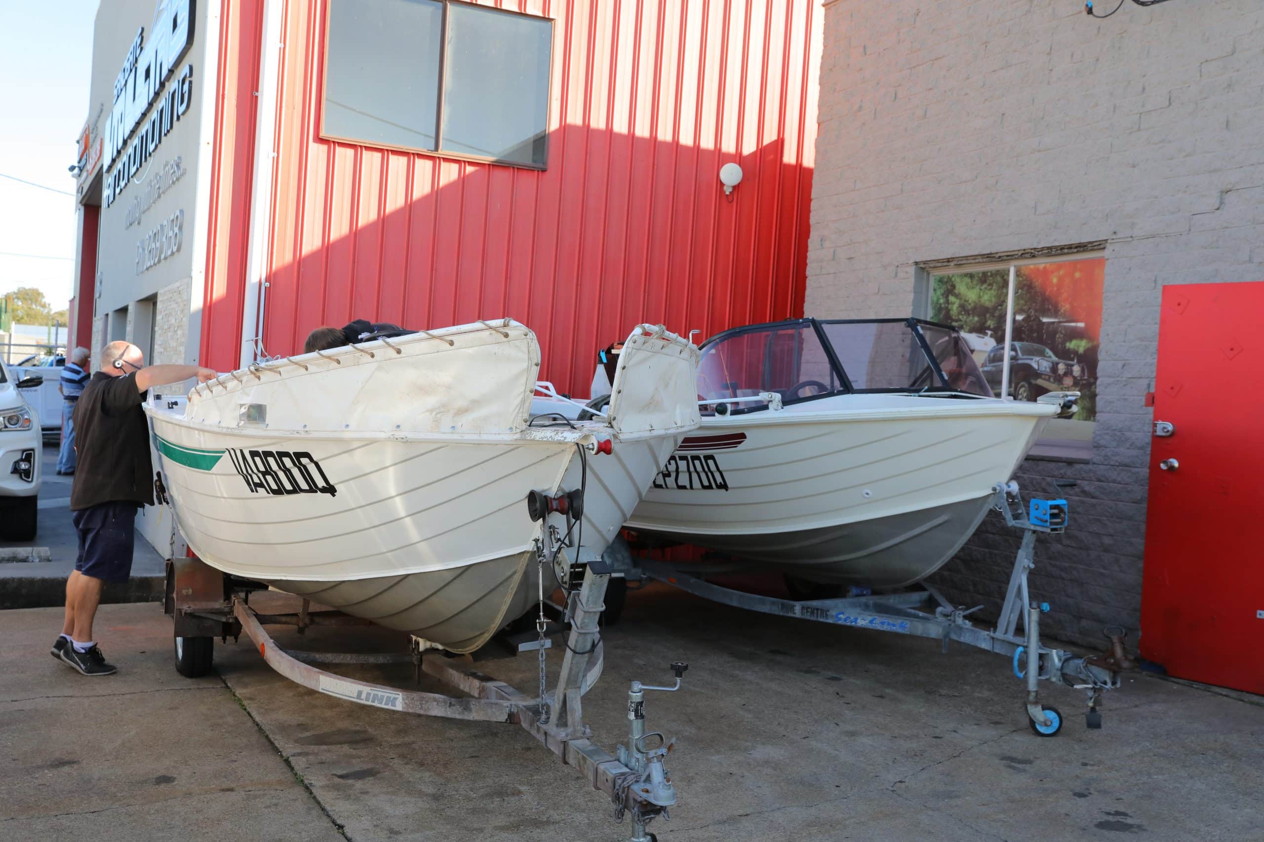 Boats awaiting repairs: Parked outside a repair shop for service