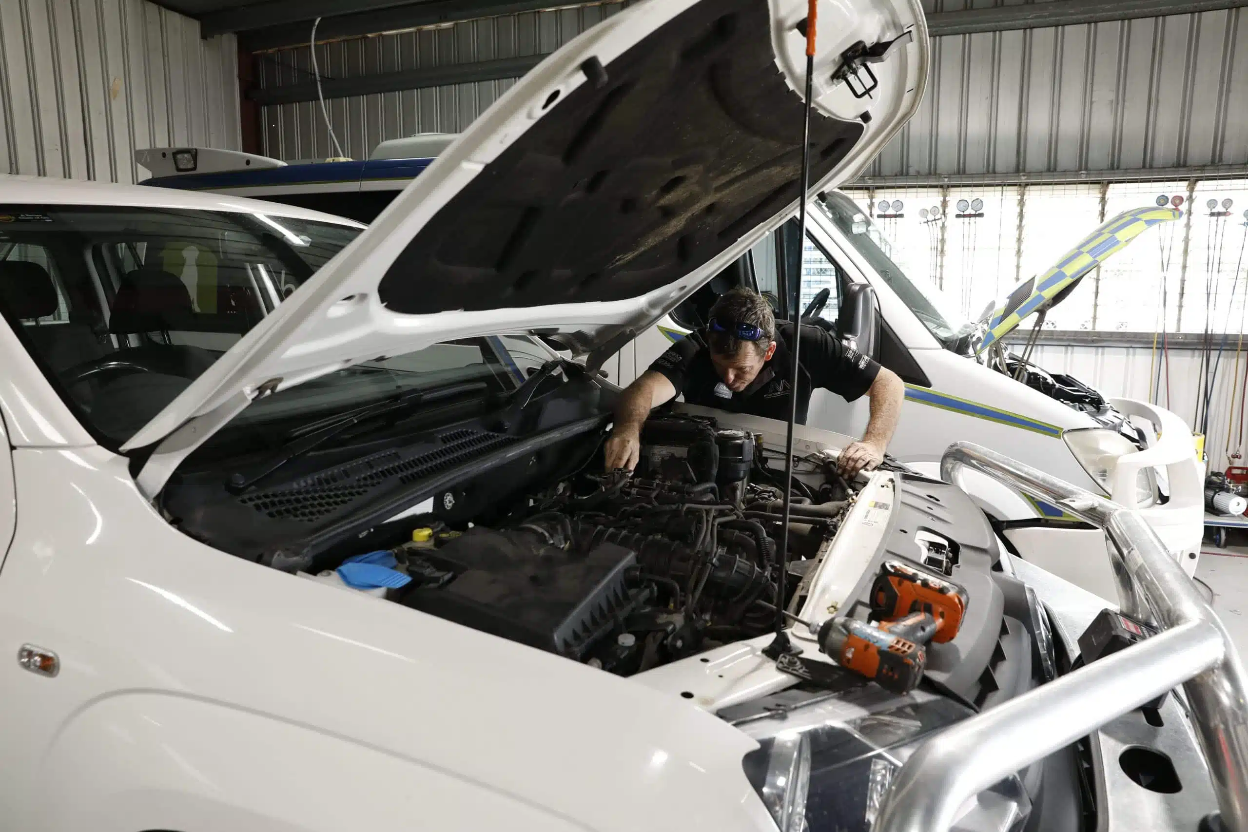 man repairing car
