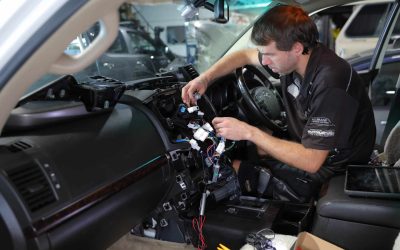 man fixing car inside