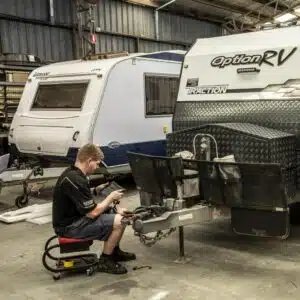 man fixing caravan 300x300 1
